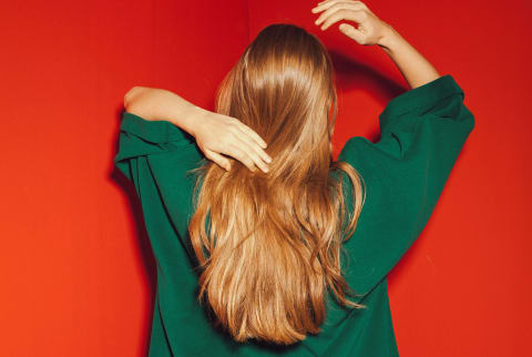 Young Blond Woman Playing With Her Hair